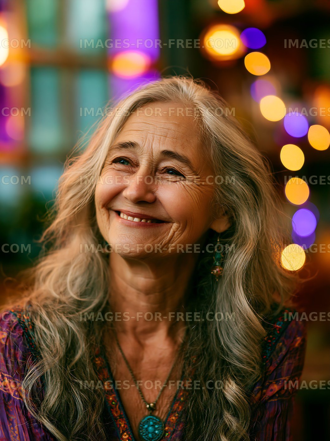Smiling woman with long gray hair in a colorful setting