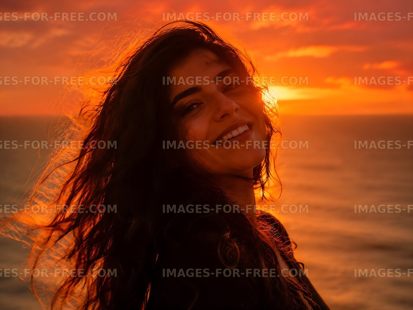 Smiling woman against sunset by the sea