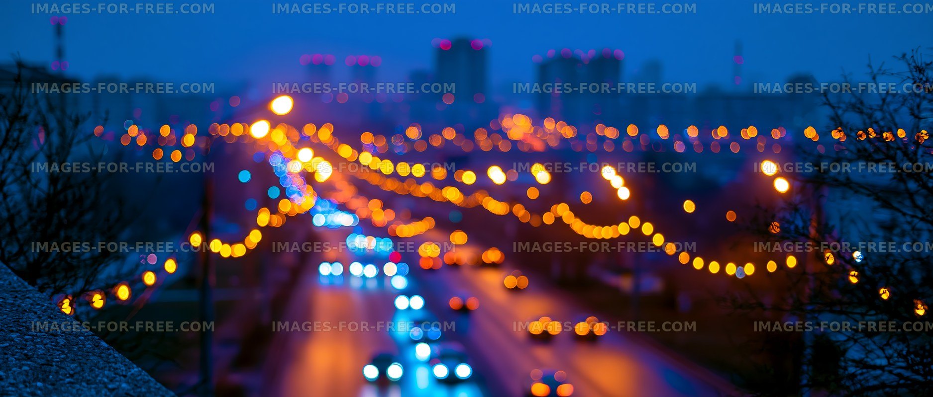 City lights at dusk with blurred traffic in the foreground