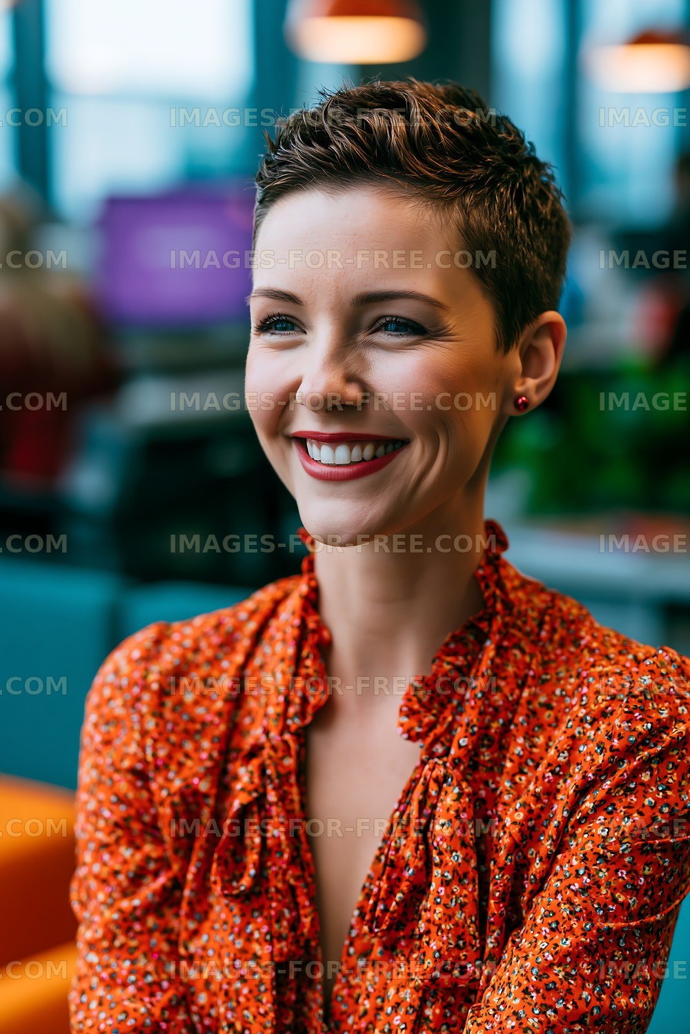 Woman smiling in a modern workspace with colorful furniture
