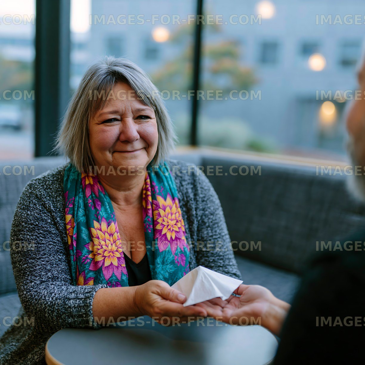 Woman hands origami to a man in a cafe