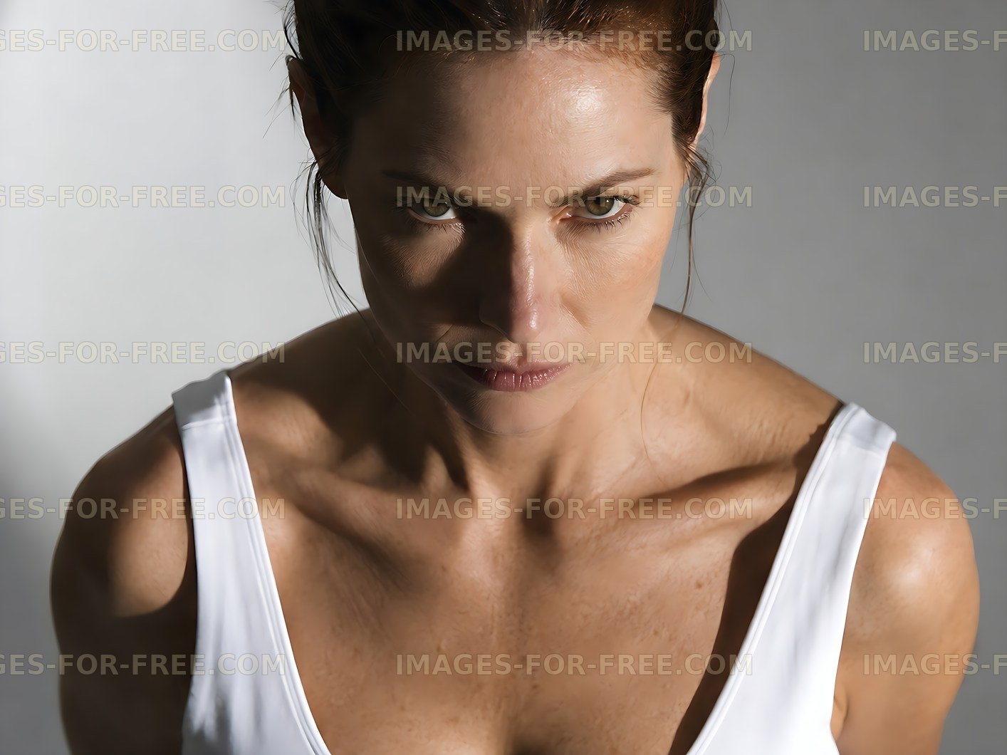 Woman in a white top looking seriously at the camera
