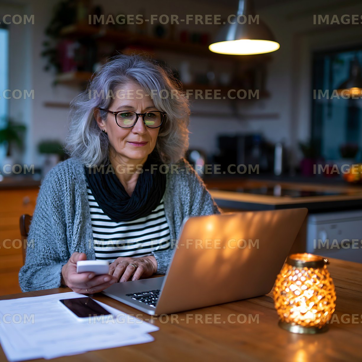Woman using laptop at home in evening