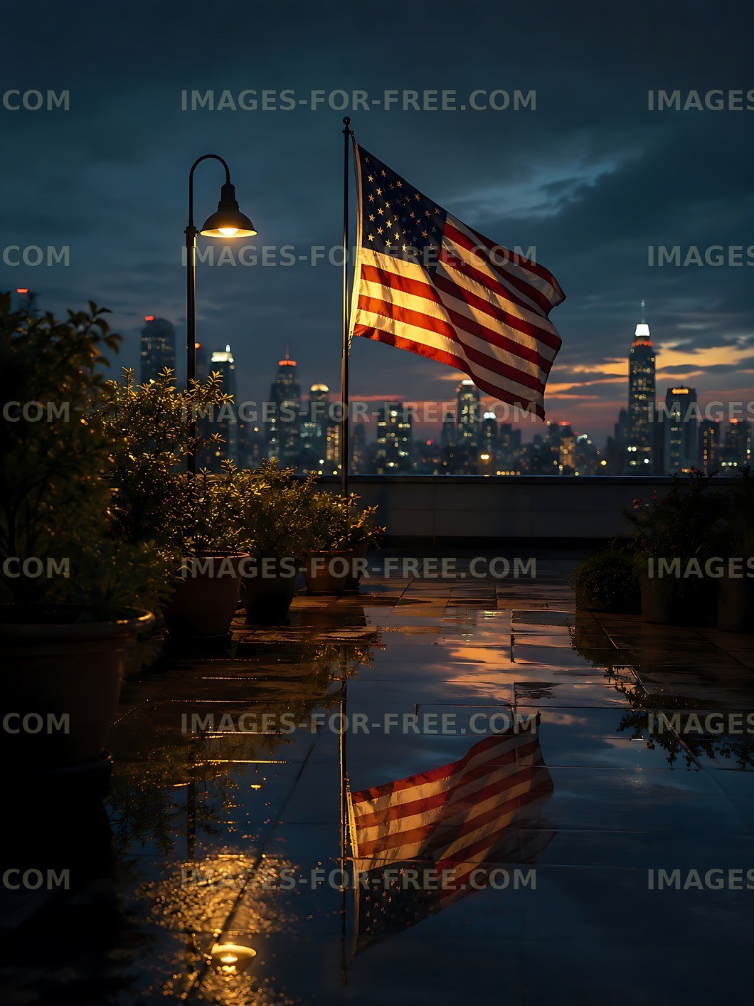 American flag waving at night on a rooftop with city skyline