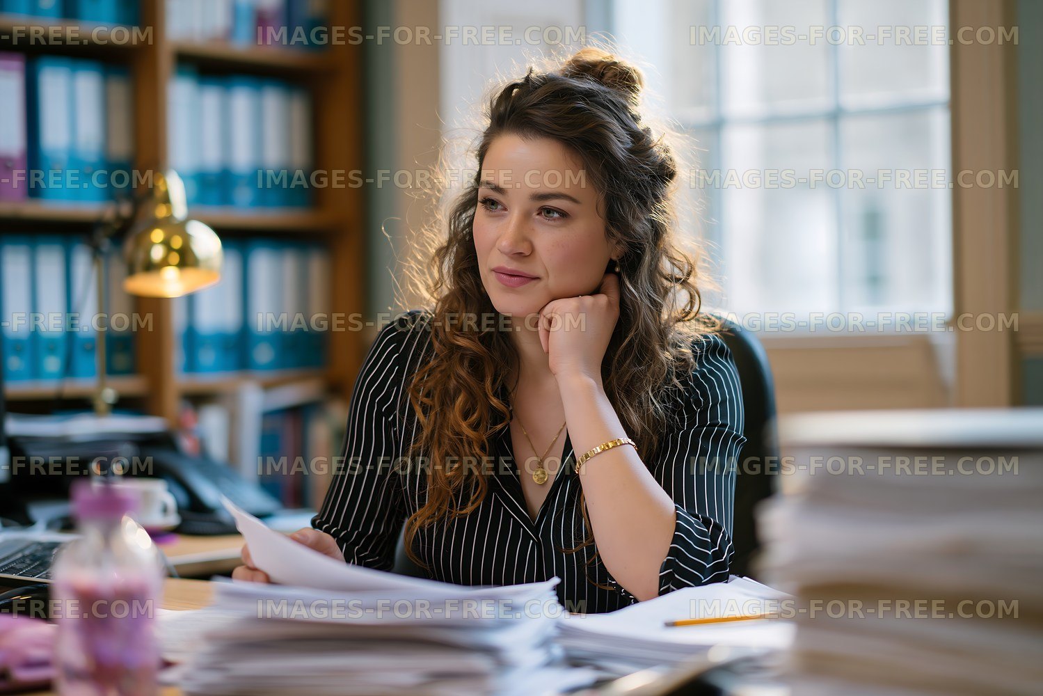 Office worker reviewing documents at a tidy desk