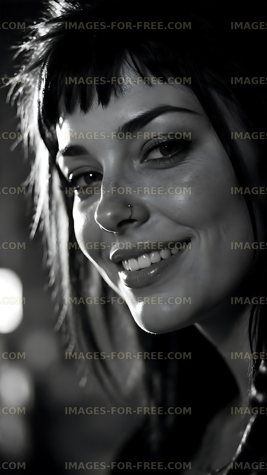 Smiling woman with dark hair and nose piercing in black and white