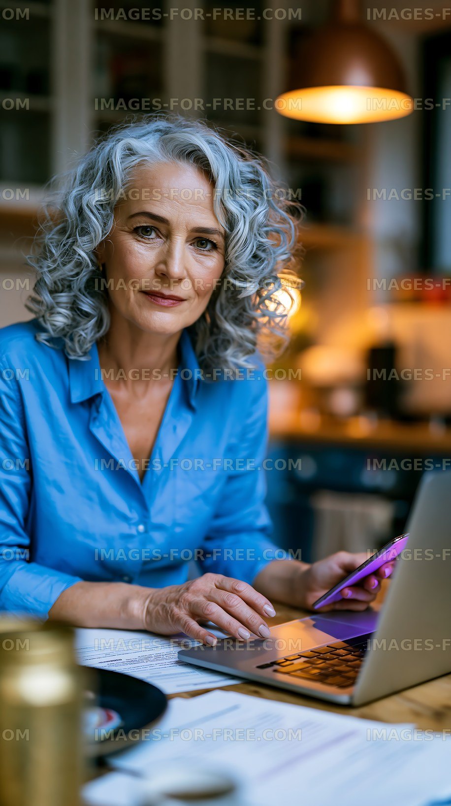 Woman working on laptop in home office environment