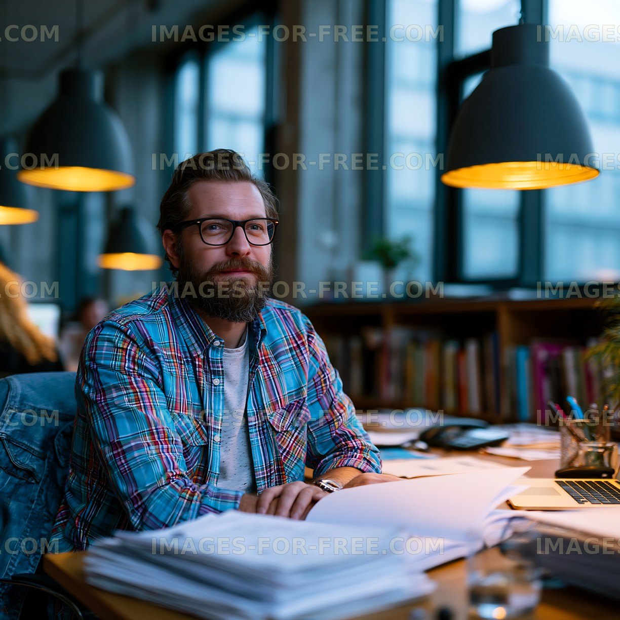 Man working at desk in modern office during evening