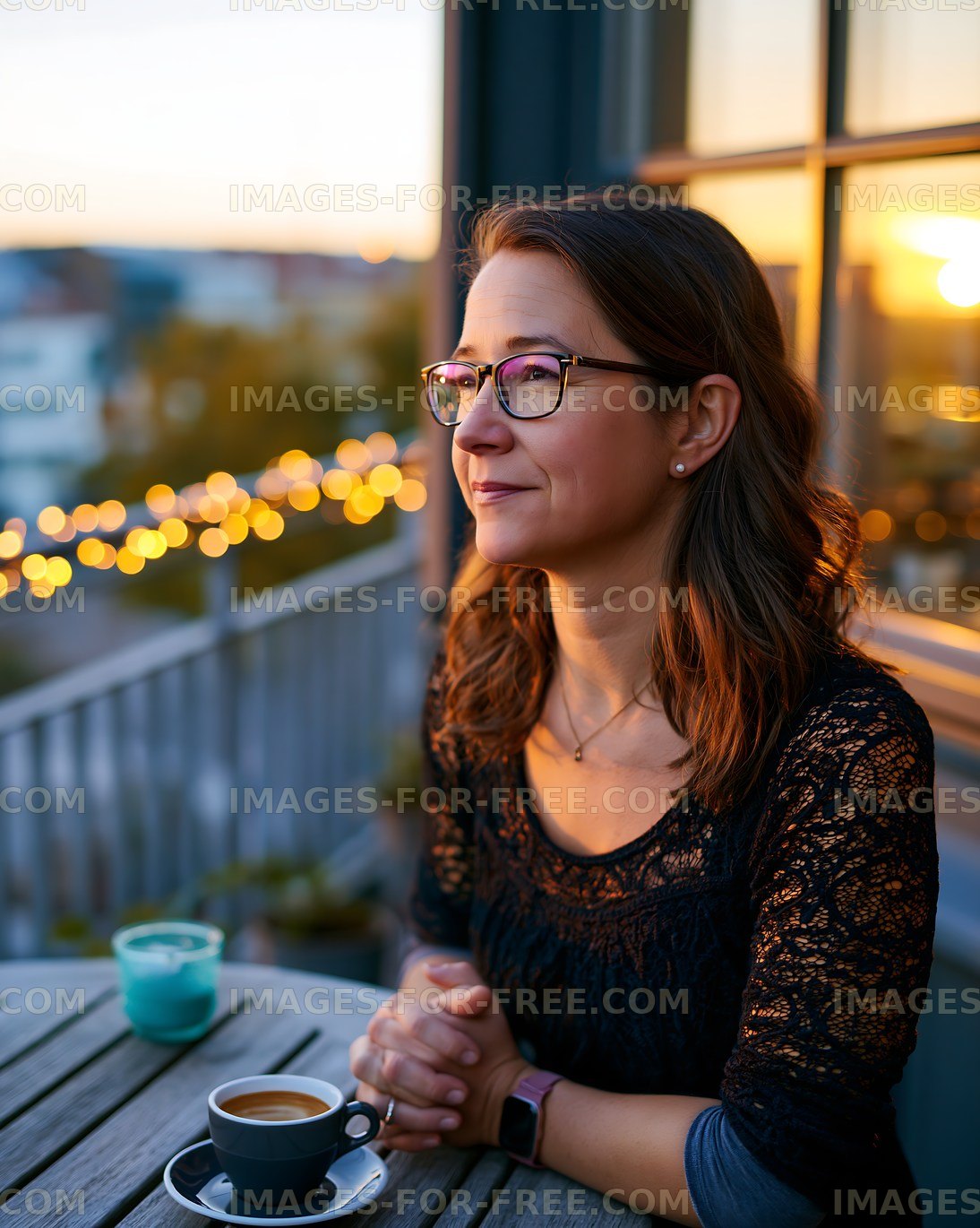 Evening coffee on a balcony with city lights in the background
