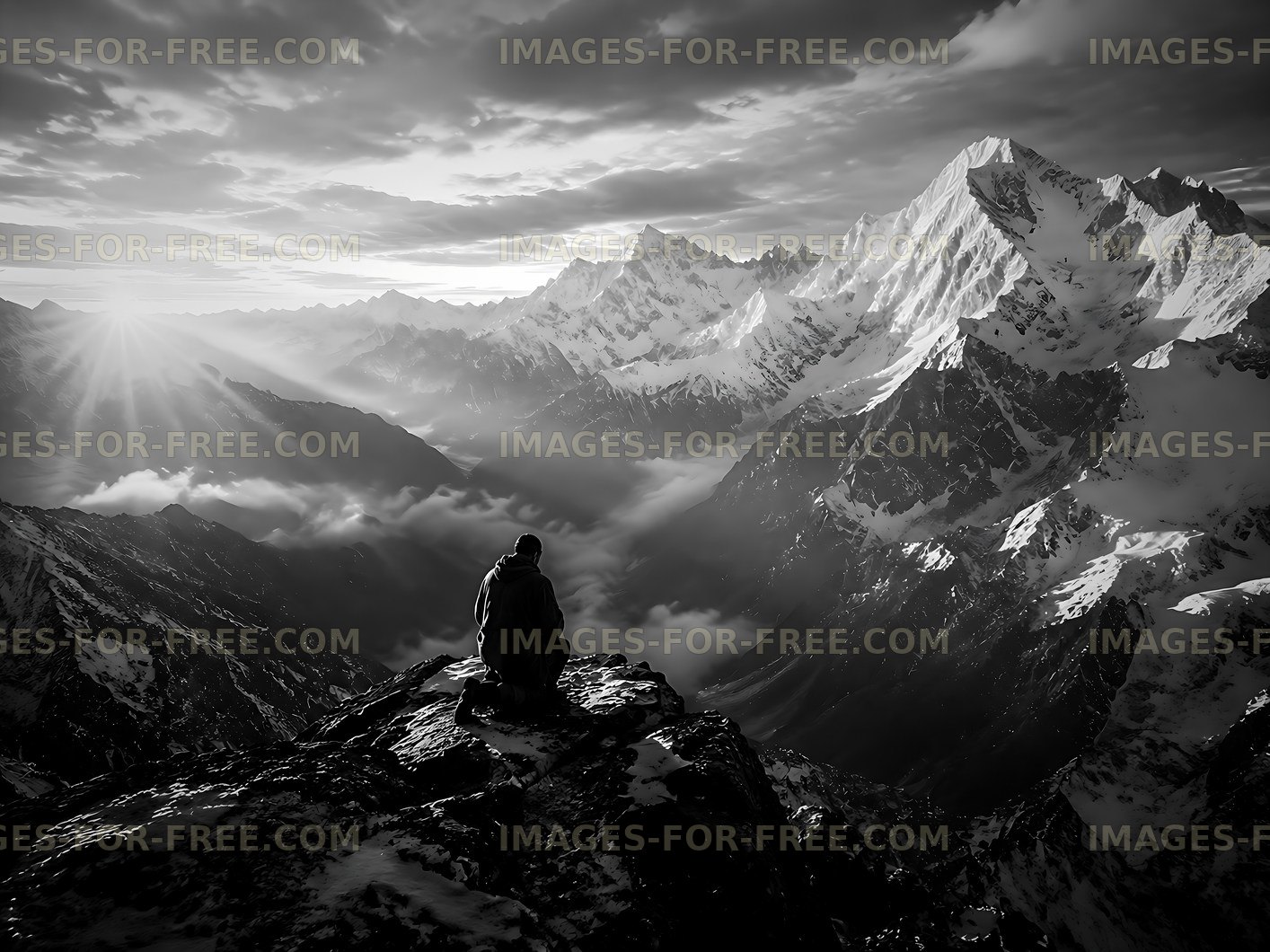 Mountain view with a person sitting alone at sunset