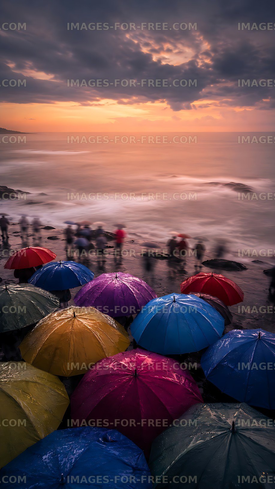 Colorful umbrellas at a rocky beach during sunset