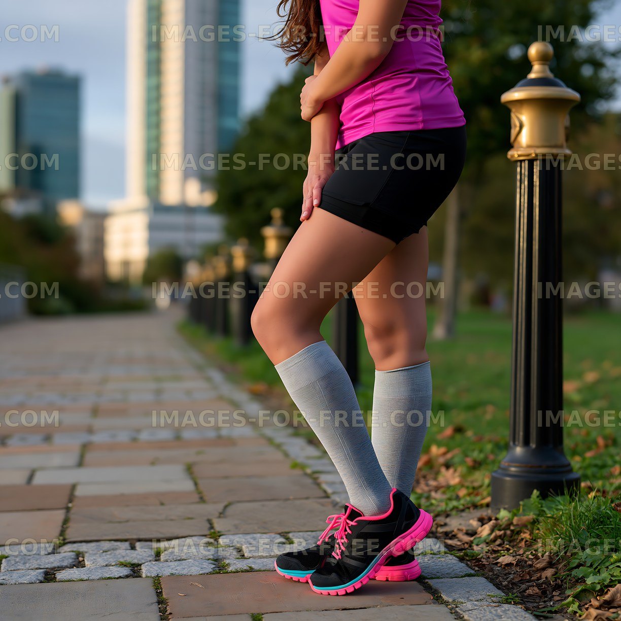 Woman running on a city path wearing sports attire