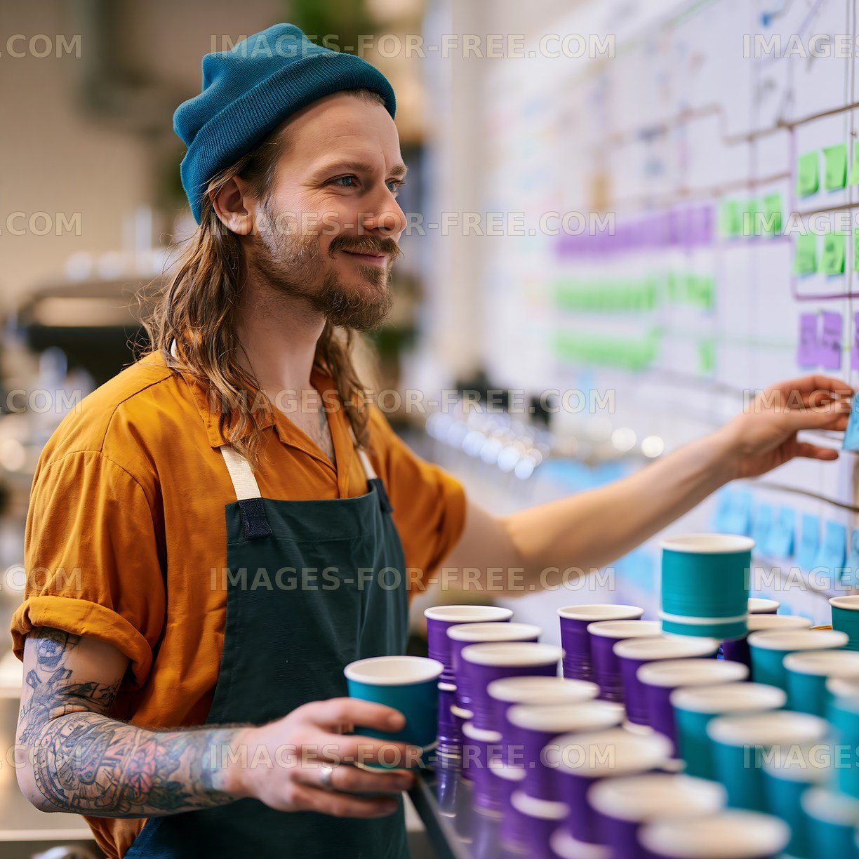 Young man working at a coffee shop making drinks