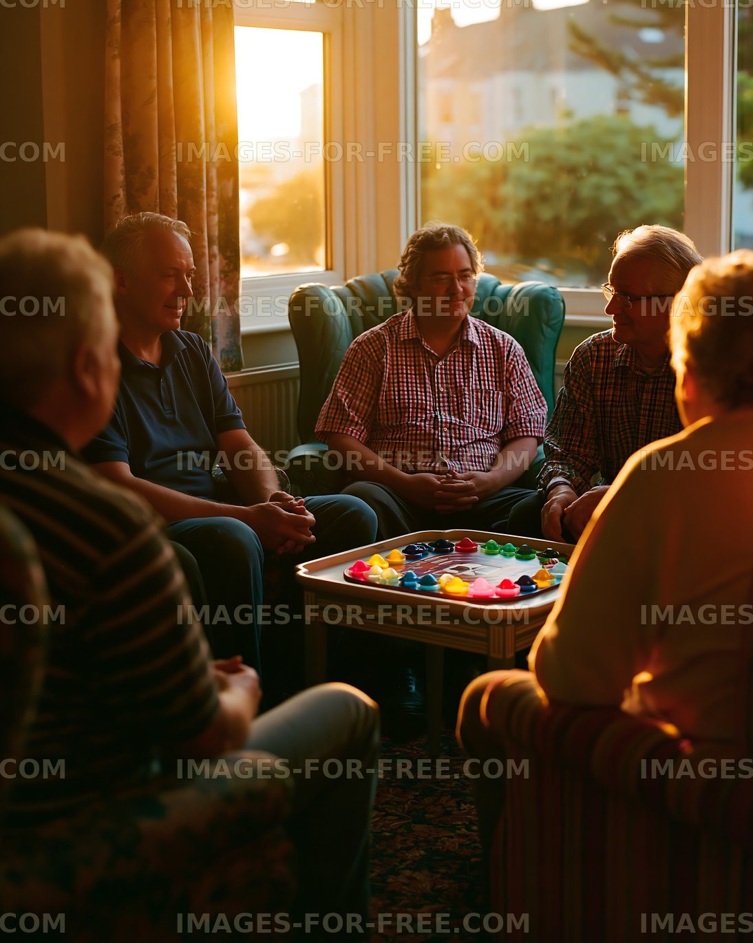 Men playing a board game in a warm-lit room during sunset