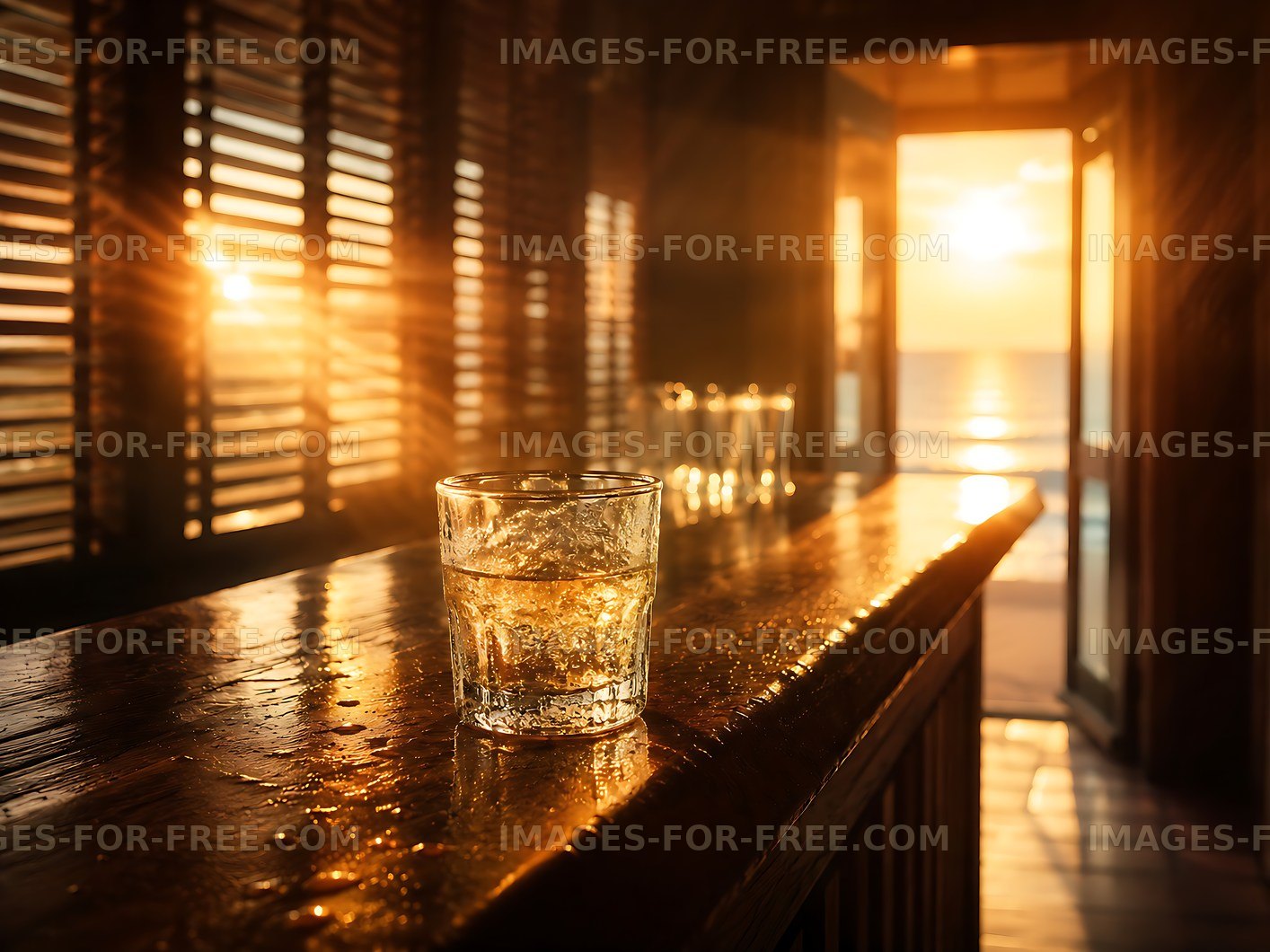 Sunset view from a beach bar with a glass on the counter