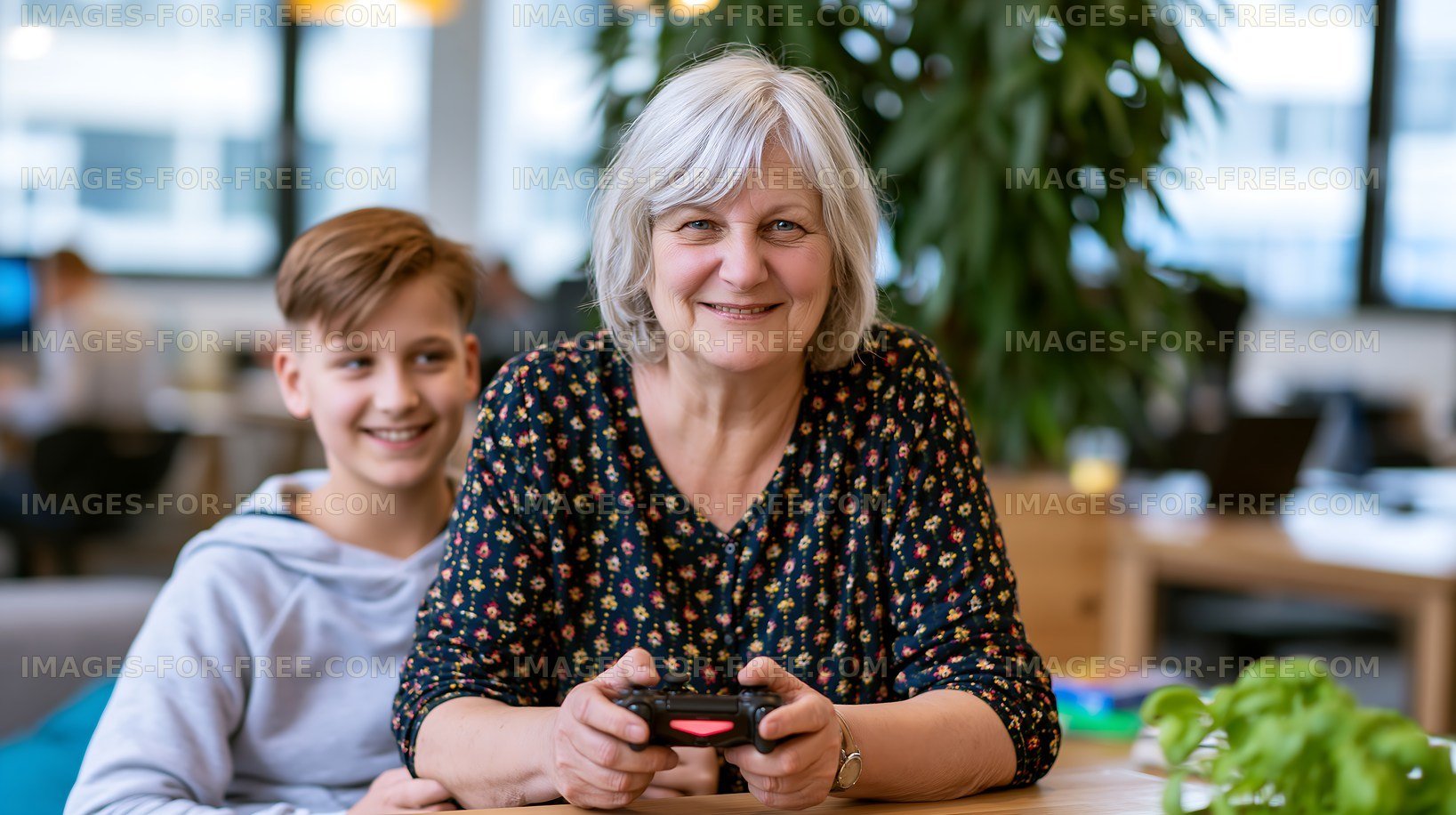 Grandmother and grandson playing video games in a modern space