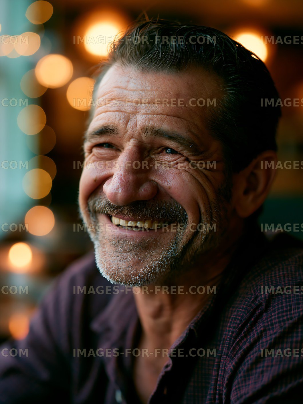 Smiling man in a cafe with warm lights in the background
