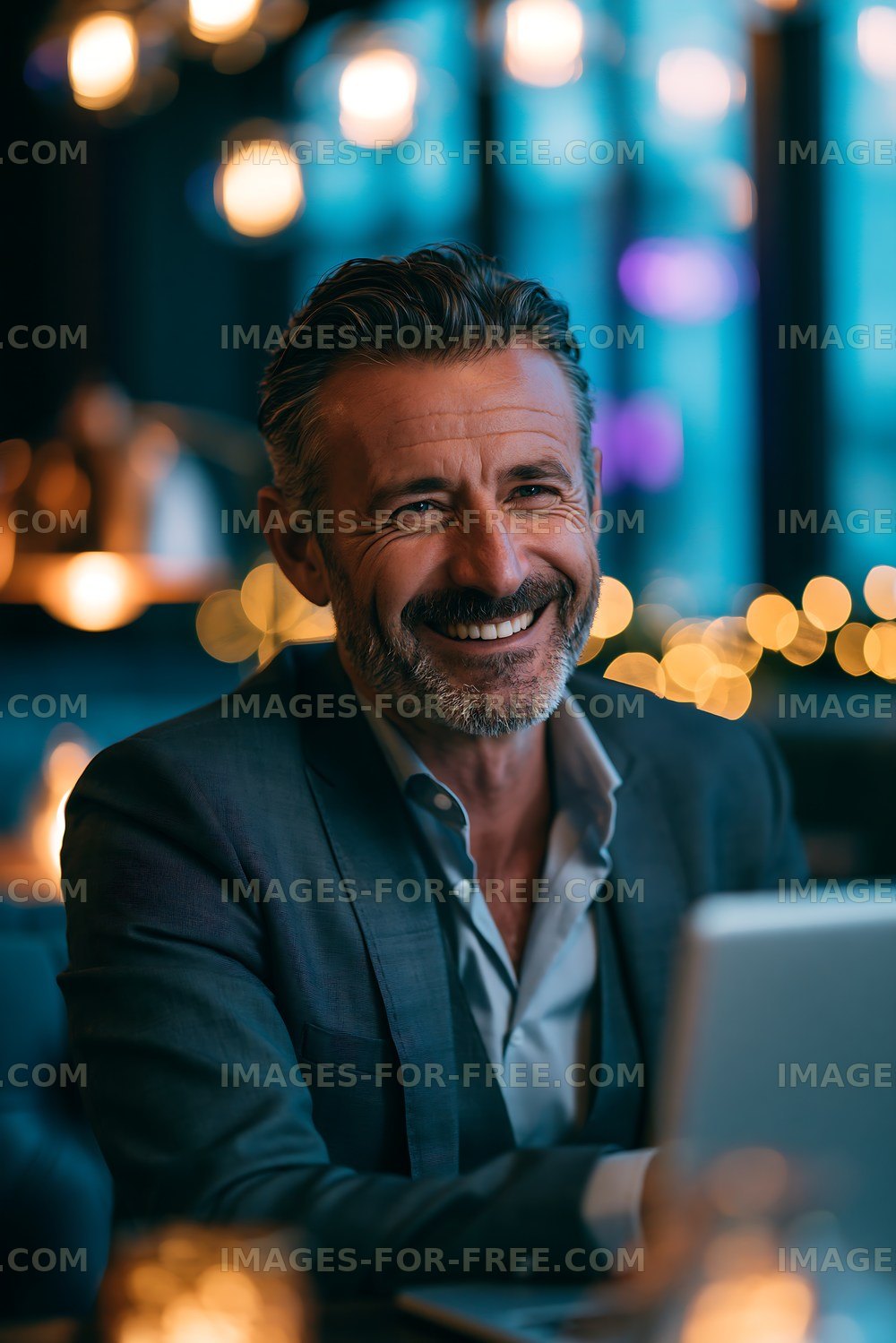 Businessman smiles at desk in modern office space