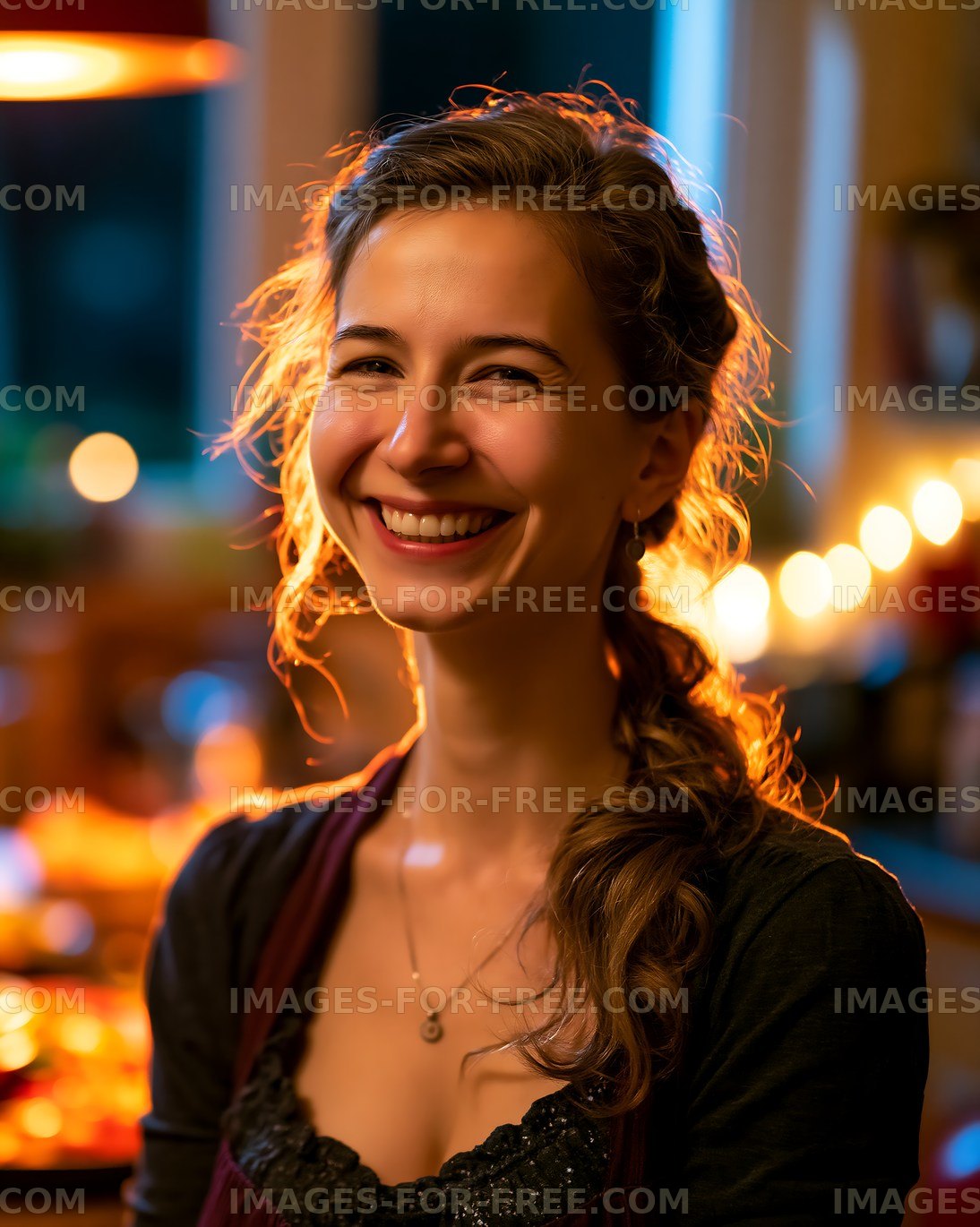Smiling woman in kitchen with warm lights at evening