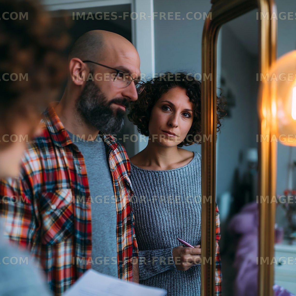 Couple looking at a mirror while discussing plans