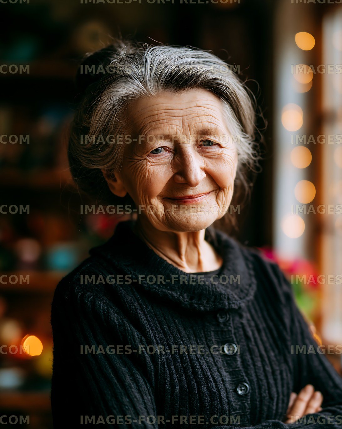 Elderly woman with gray hair smiling in a cozy indoor setting