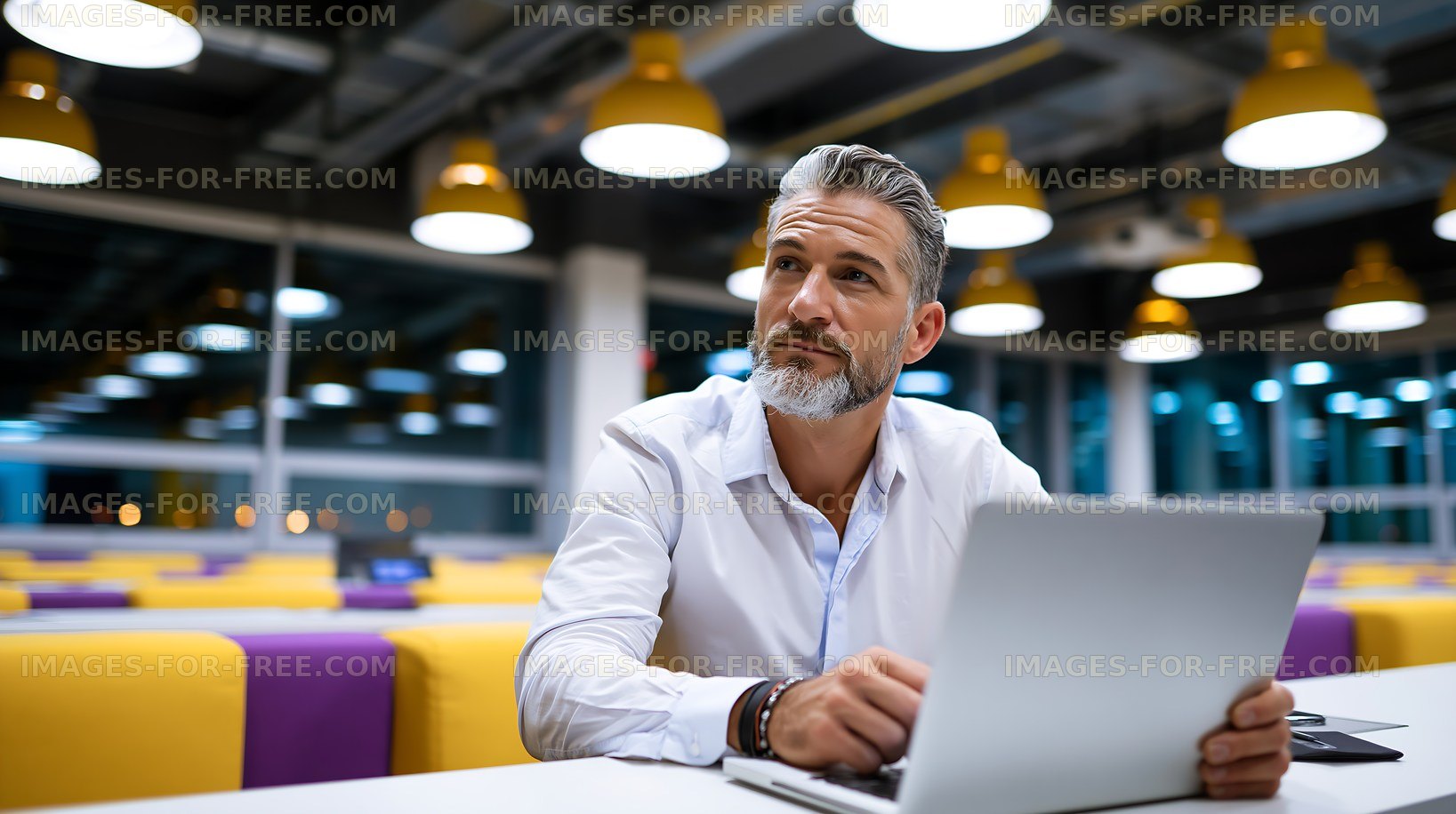 Man using laptop in modern coworking space