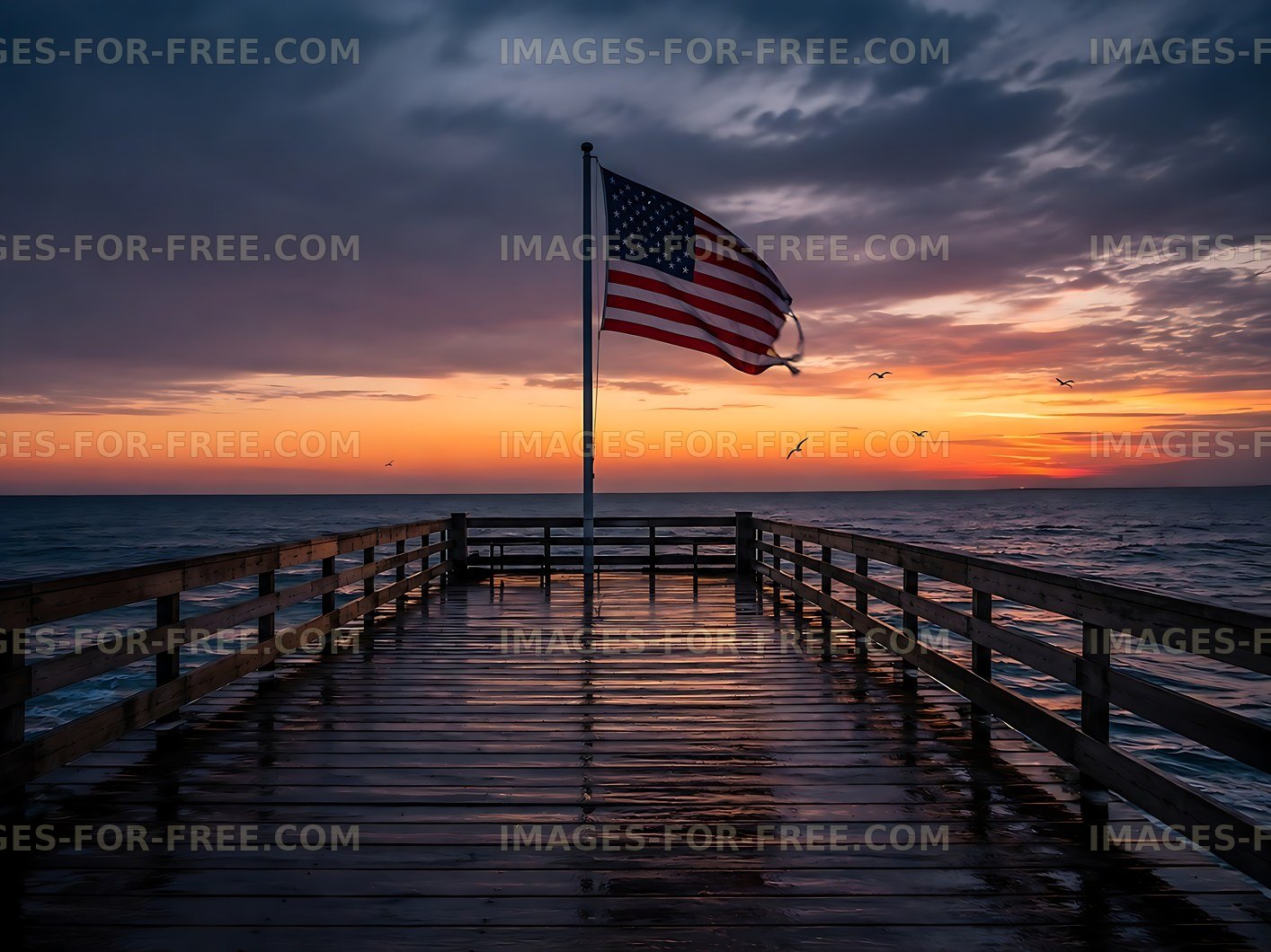 Sunset over ocean pier with American flag in the foreground