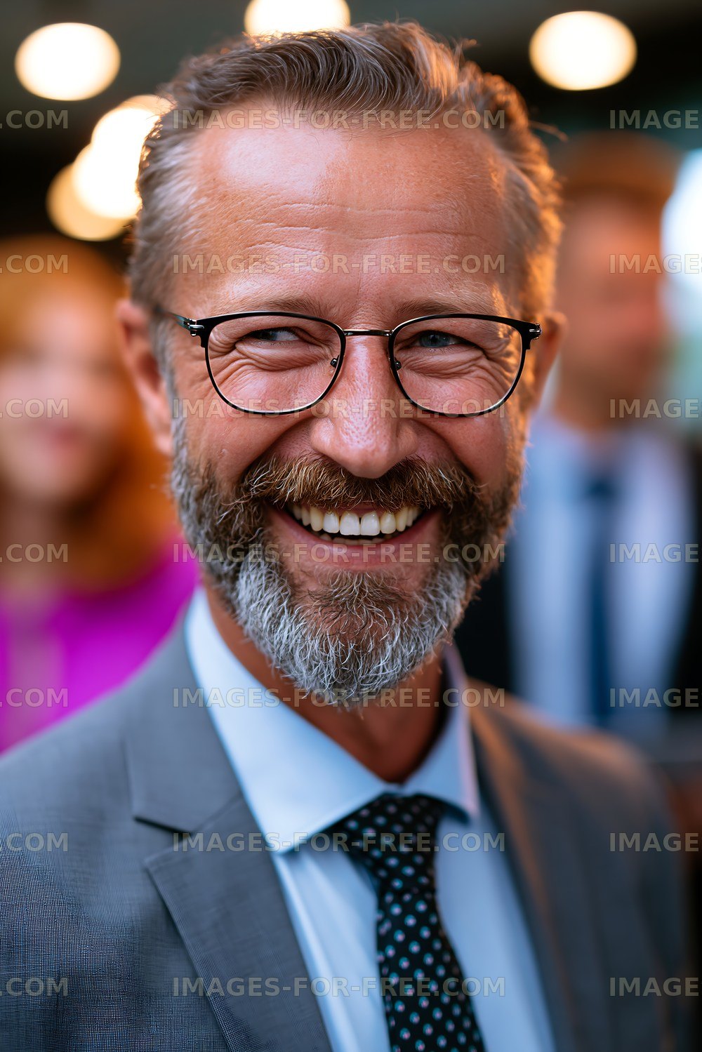 Man smiling at outdoor event with blurred crowd behind