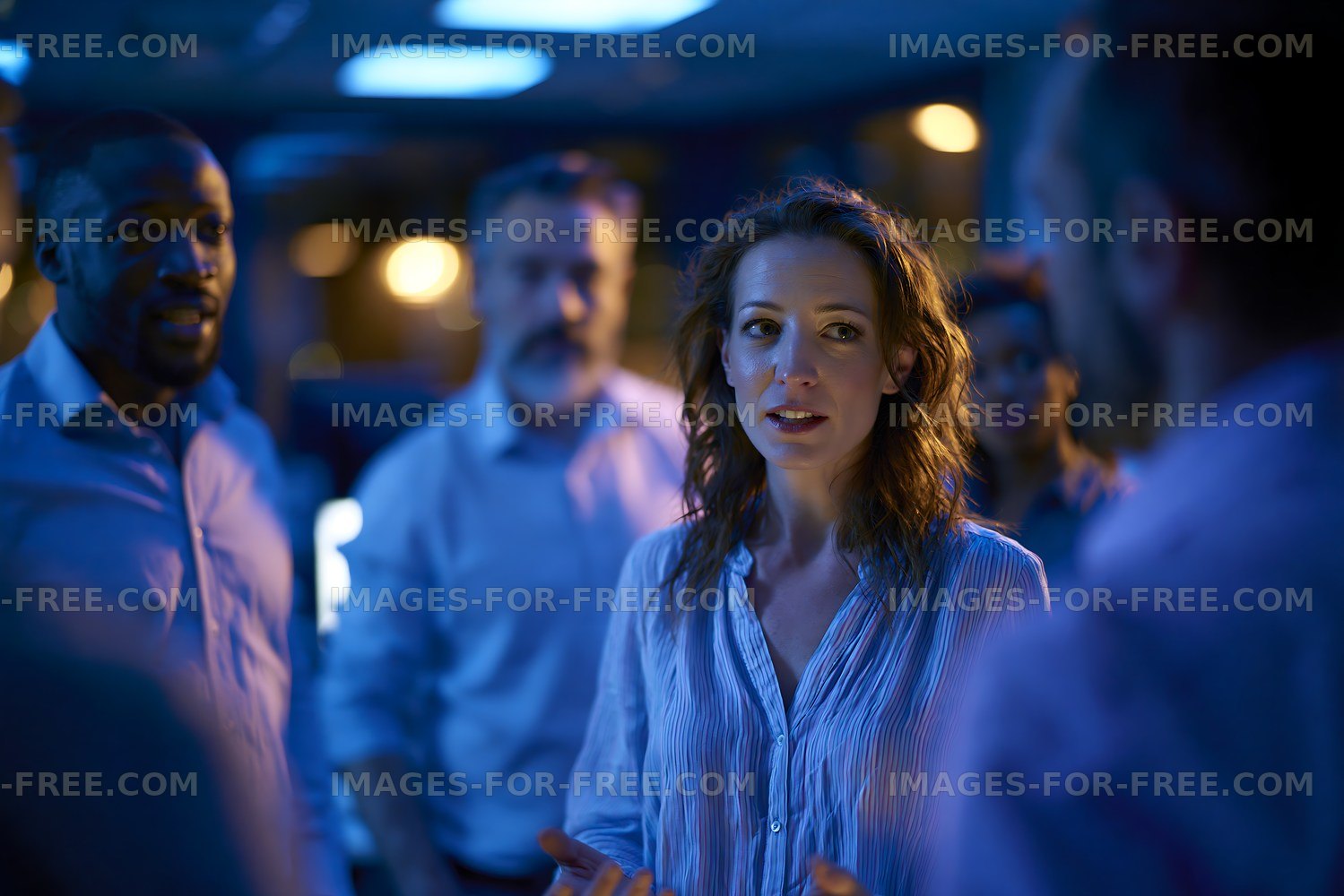 Group discussion in office under blue lighting
