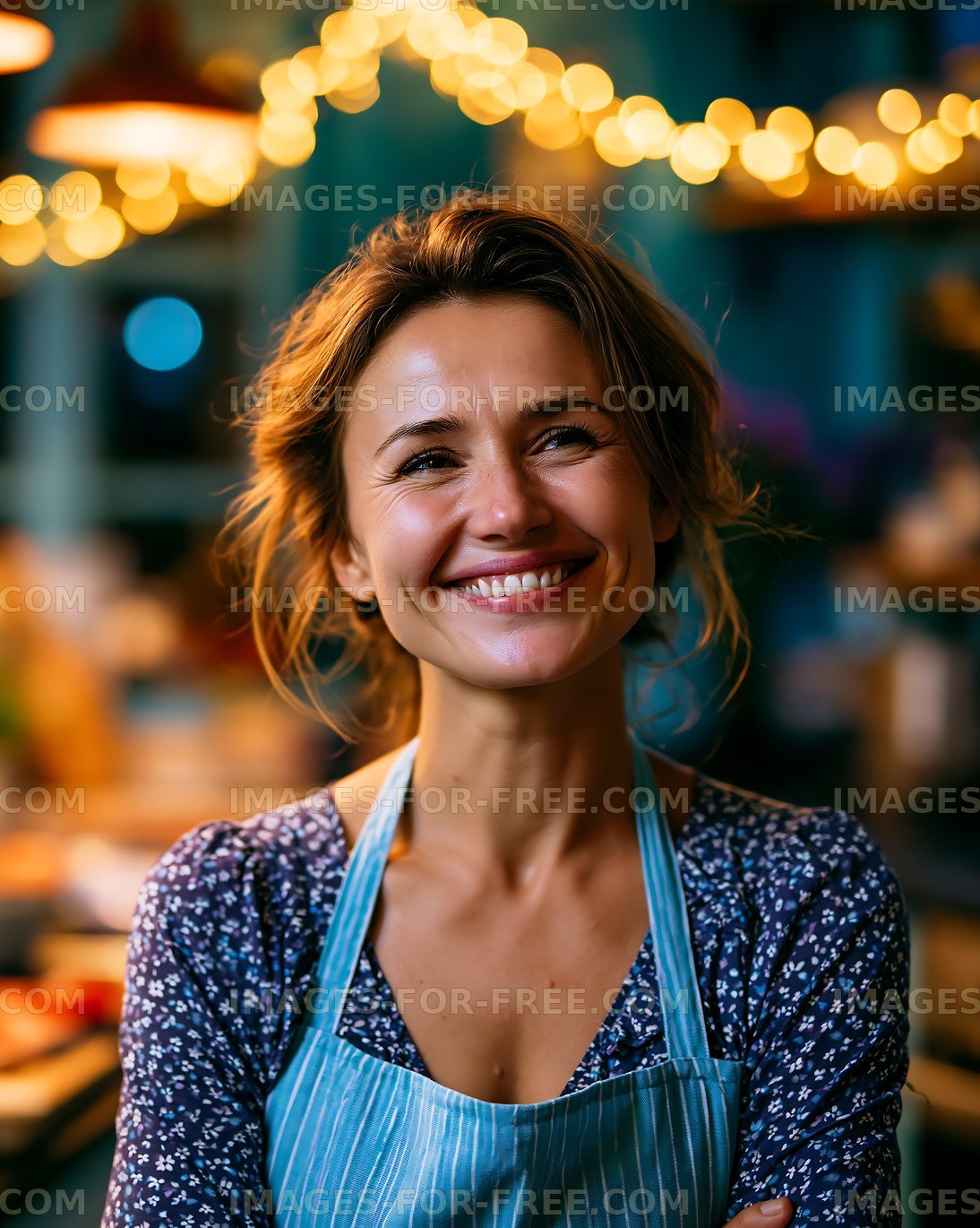 Woman smiling in apron at cafe with warm lights