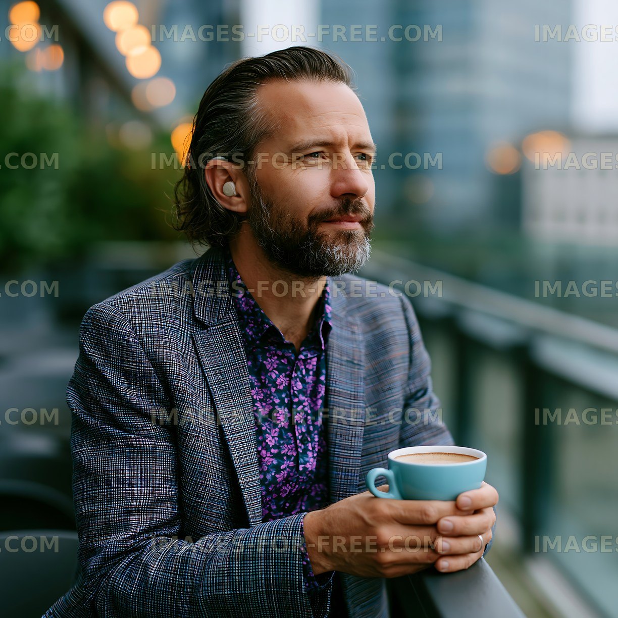 Man sipping coffee on balcony with city view