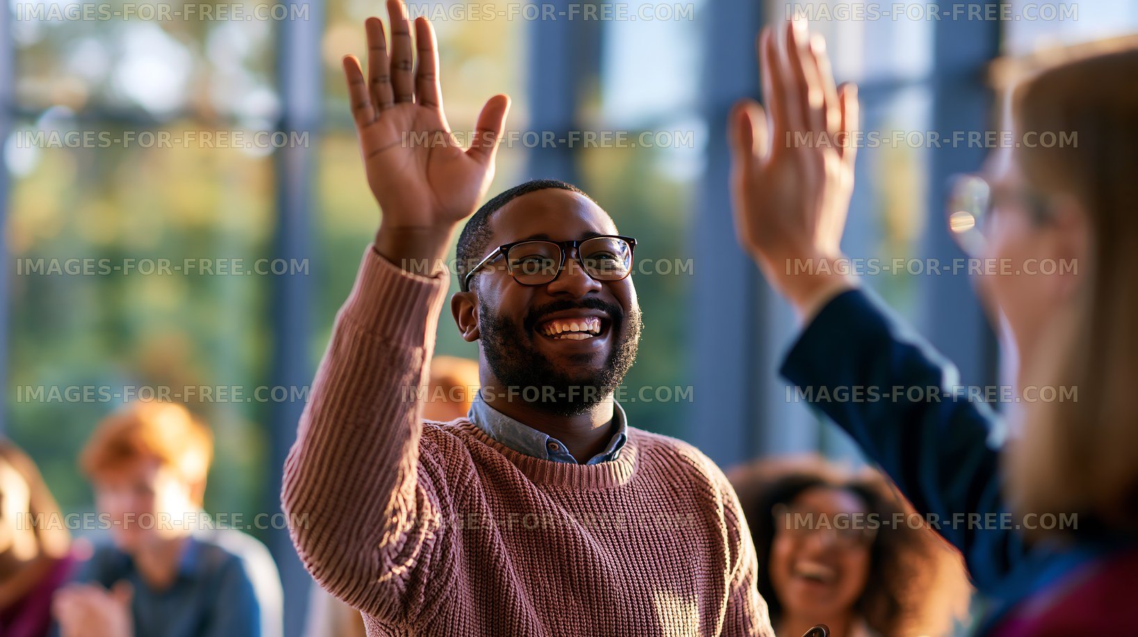 Man smiling and waving with group of people in a meeting