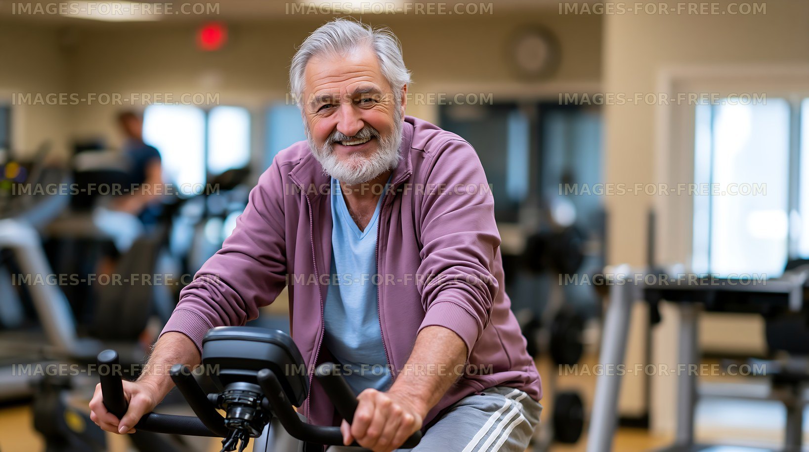 Senior man exercising on stationary bike in fitness center