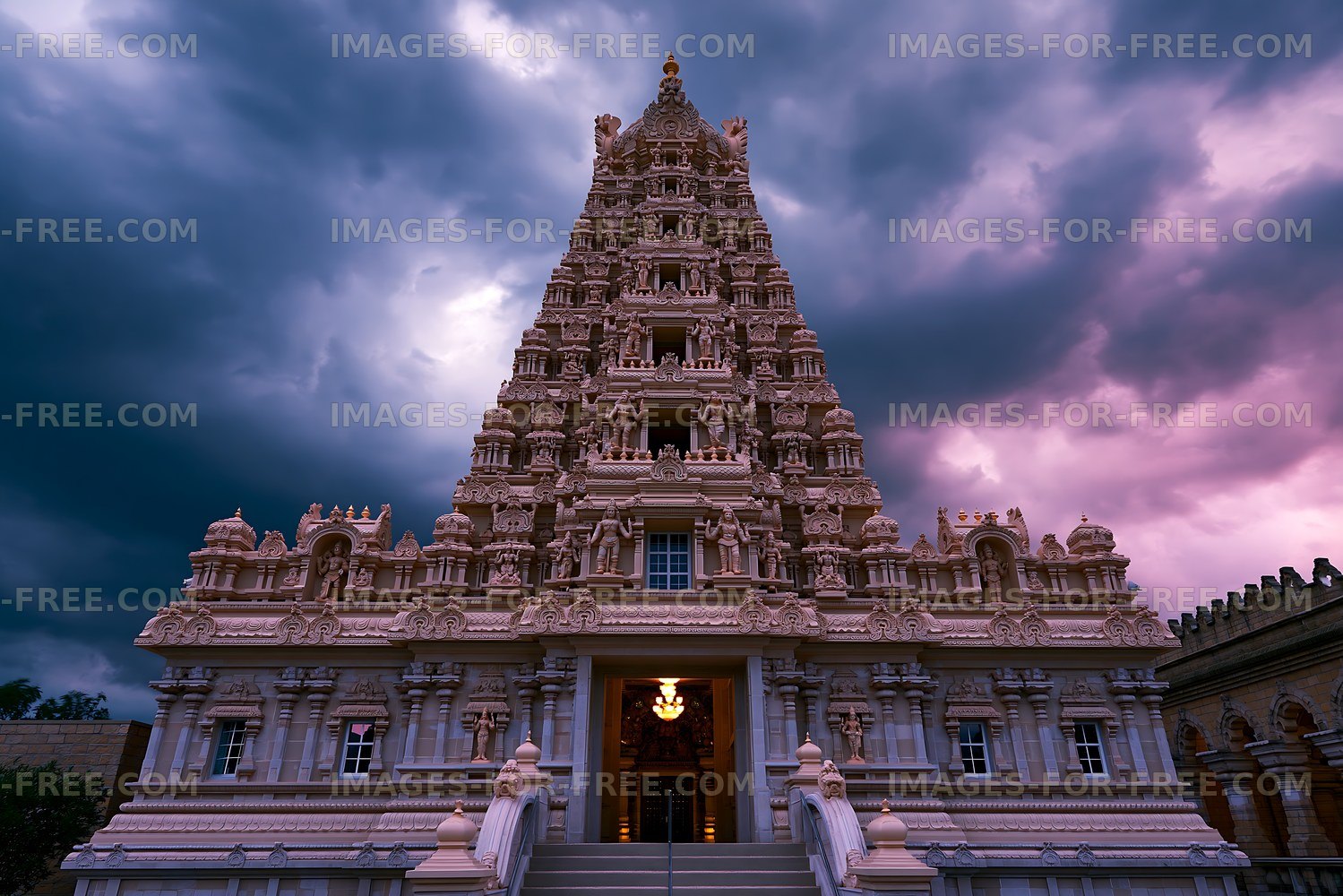 Hindu temple under dramatic sky at dusk in India