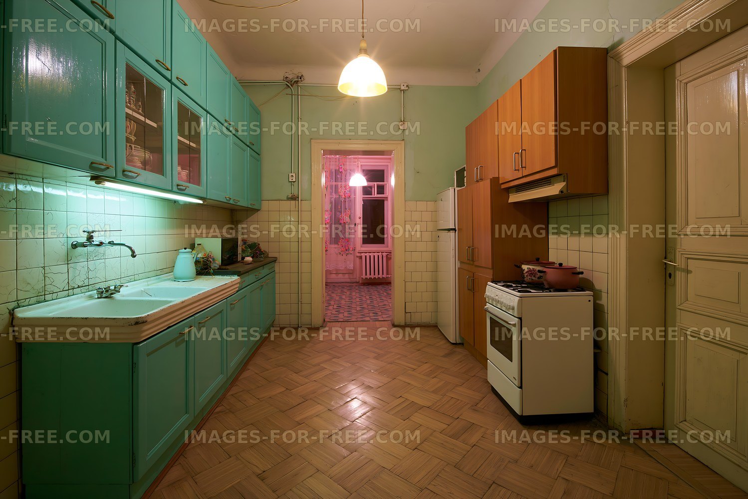 Kitchen with teal cabinets and wooden floors in a vintage apartment