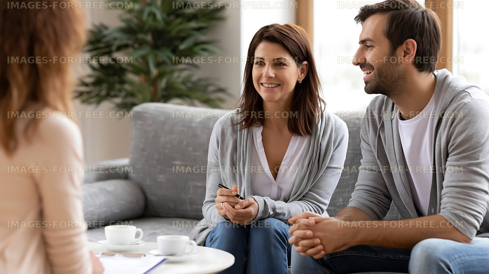 Couple discussing plans with advisor in a modern indoor setting