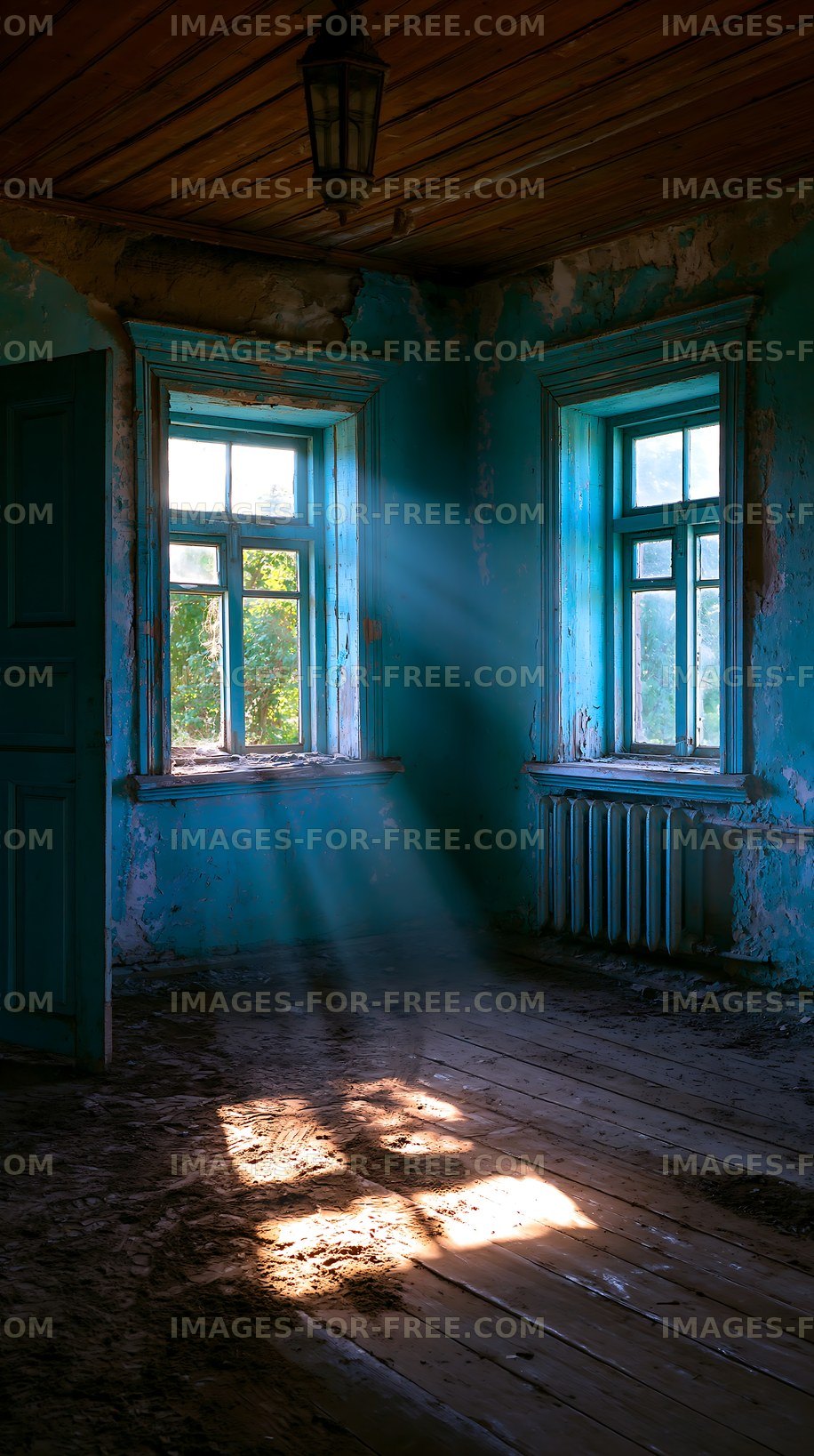 Light shines through windows in an old, abandoned room