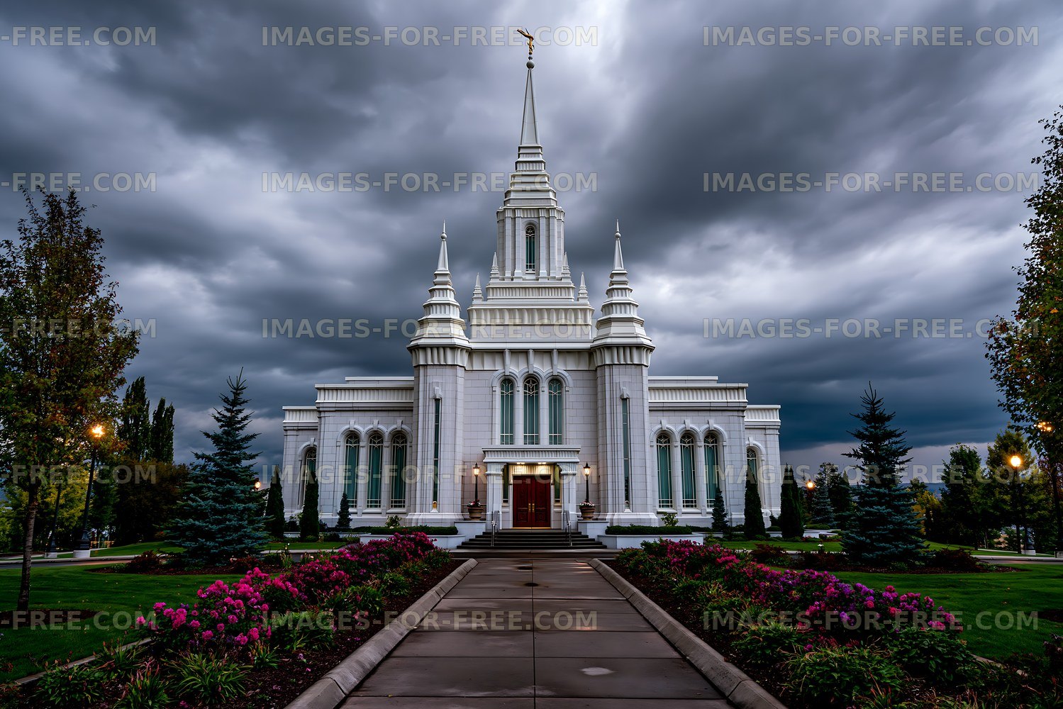 Large white building with a tall spire under a cloudy sky