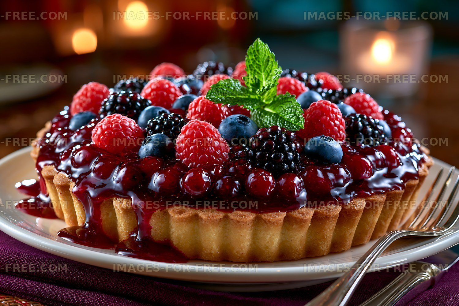 Fruit tart with berries and mint served on a plate