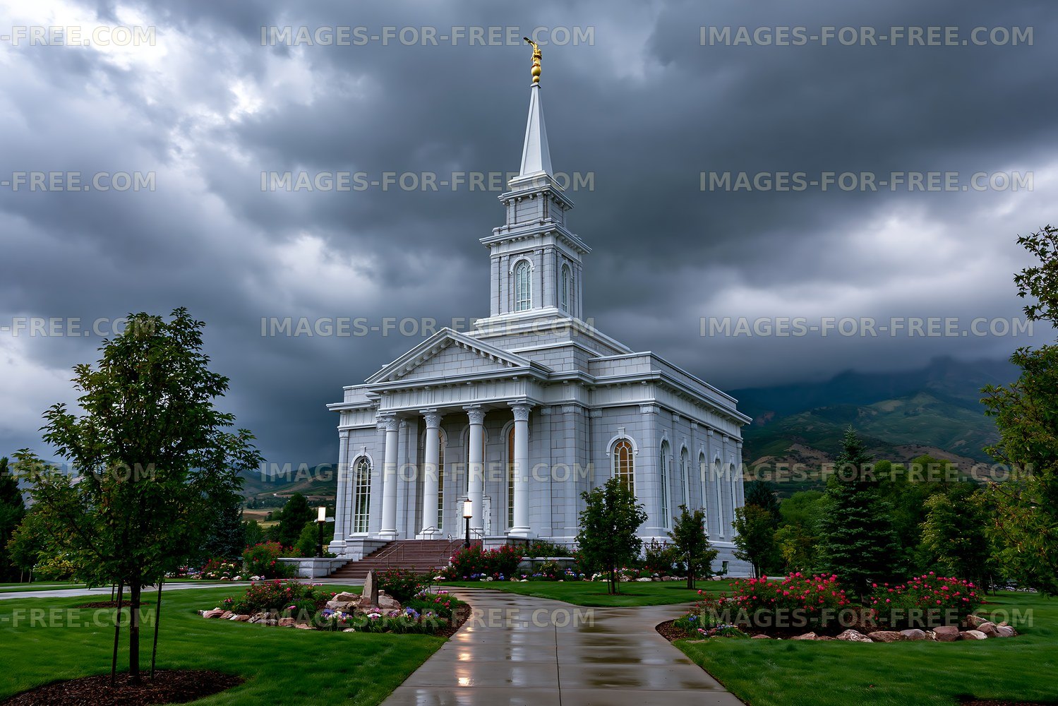 Cloudy day at a large white church building with a tall spire