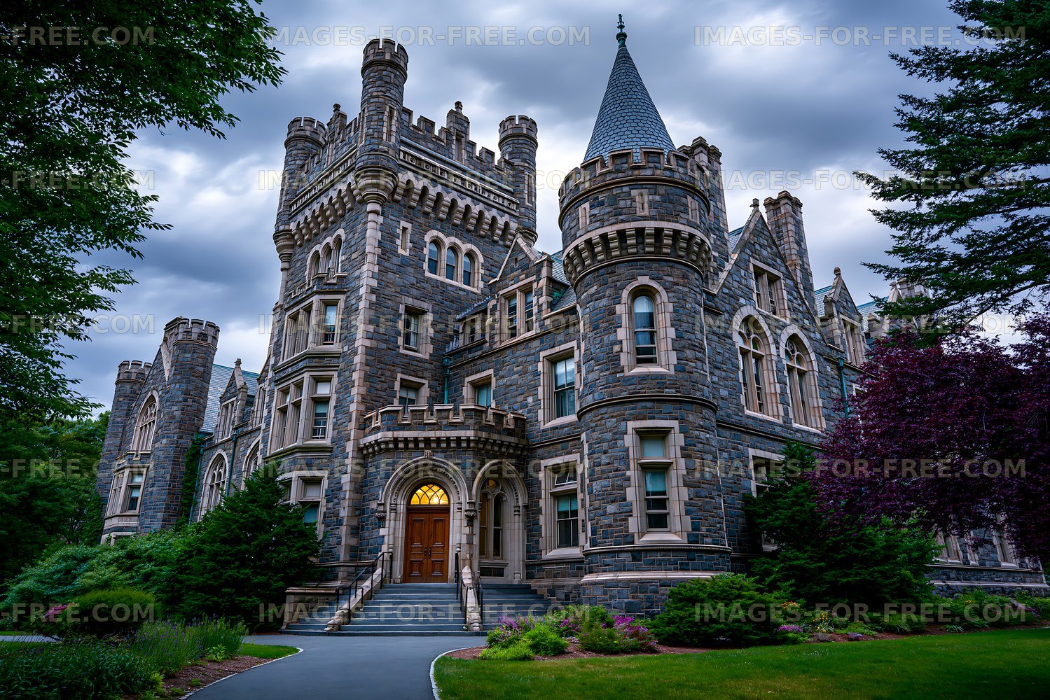 Stone castle with towers and green landscape in cloudy sky