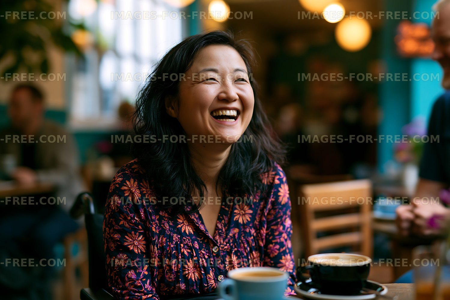 Woman laughing in a cafe while enjoying coffee with friends