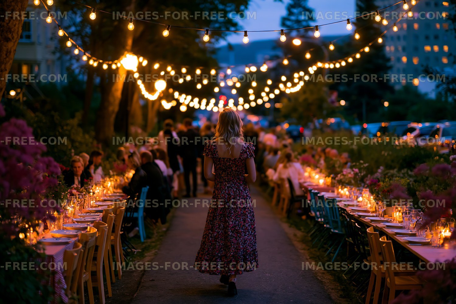 Evening outdoor dining event with string lights and guests