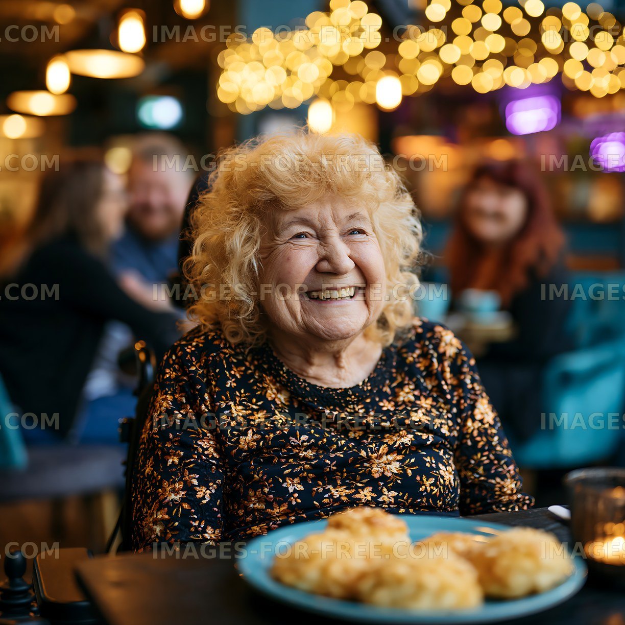 Smiling elderly woman sitting in a cafe with food on the table