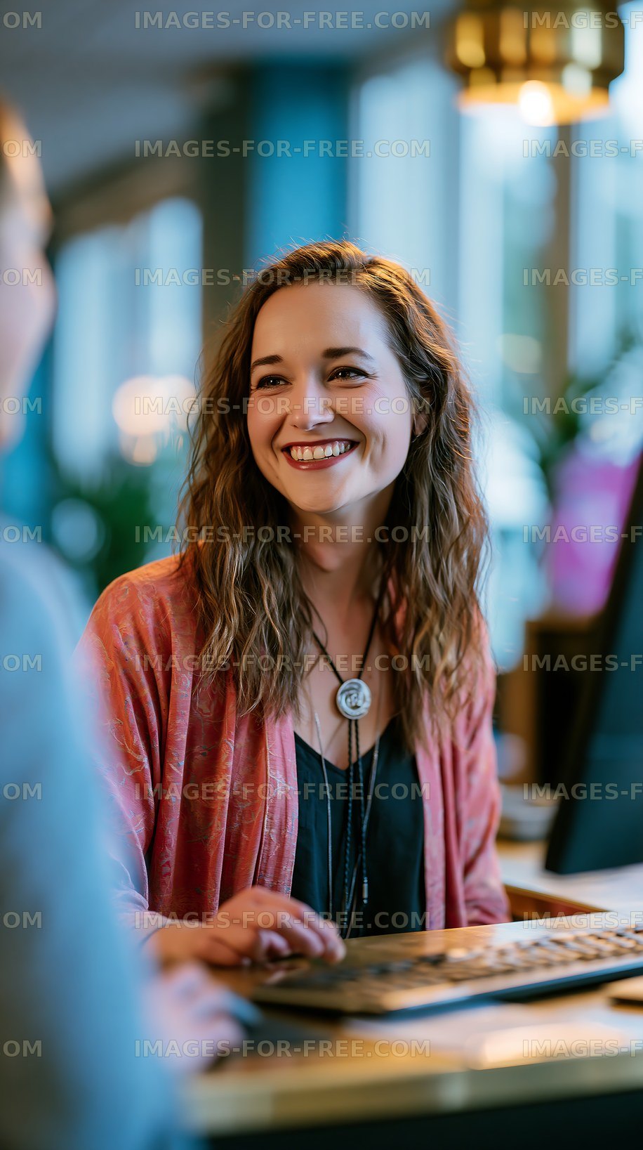 Smiling woman at a counter in a modern cafe