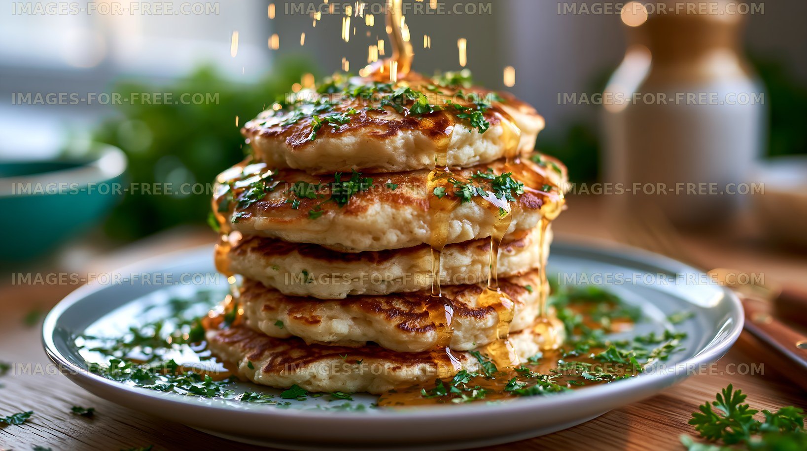 Fluffy pancakes stacked high with syrup and herbs on a plate