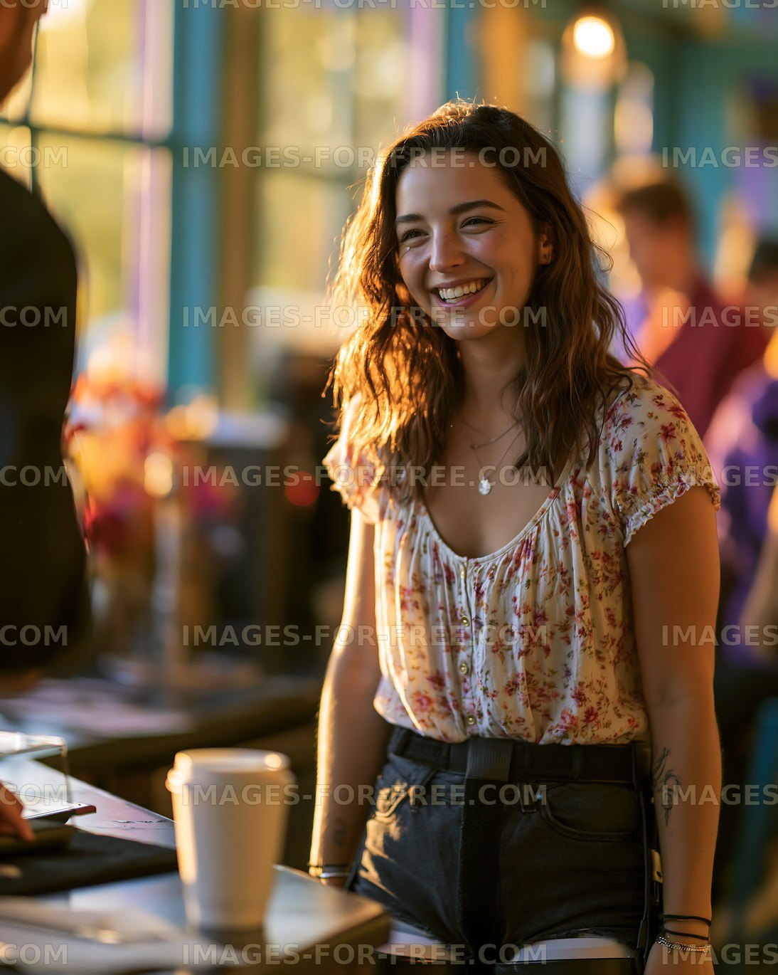 Woman smiling in a coffee shop during daytime