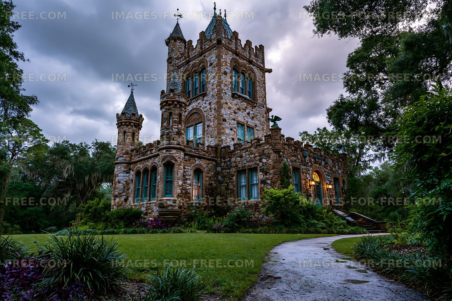 Historic stone castle surrounded by trees in evening light