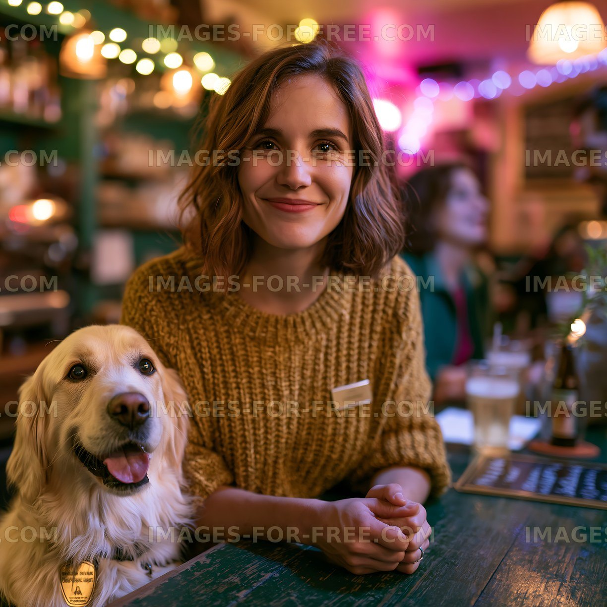 Woman sitting in cafe with dog during evening hours