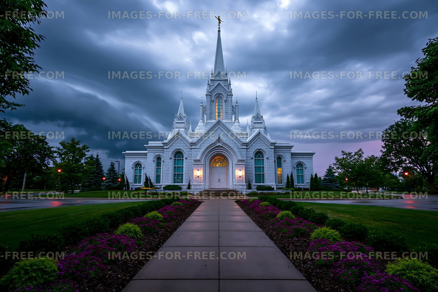 Cloudy sky over a large white church with a tall steeple